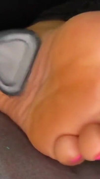 Ebony Girl Gives Her Feet a Massage with a Massage Gun