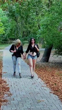 Two Lesbian Mistresses Are Strolling Through the Park
