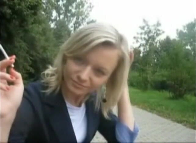Femdom Austria: Blonde beauty smoking a cigarette outdoors