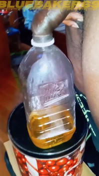 Pissing in a Large Juice Container