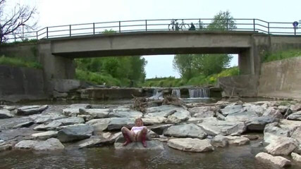Femdom Austria: Blonde pissing outside in a river
