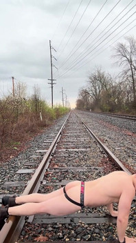Dios muscular asiático empapado por la lluvia en Jockstrap rebota pecas, muestra v-taper y come su carga masiva en las vías del tren