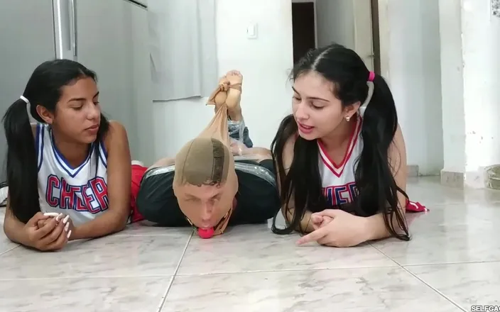 Selfgags femdom bondage: Football Player Pantyhosed and Hogtied on the Floor by Two...