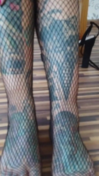 Tattooed lady in fishnet pantyhose