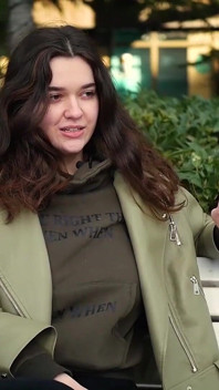 Young Brunette Is Taking an Unhurried Stroll with Allwhite 120mm Cigarette