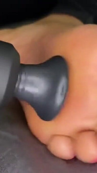Ebony Girl Gives Her Feet a Massage with a Massage Gun