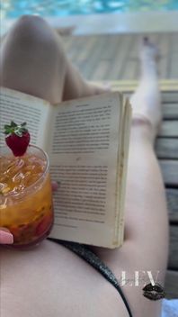 Reading by the Pool in a Bikini That Barely Counts as Spf
