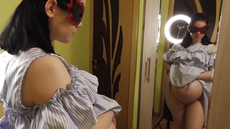 Anna Sky: Pregnant Anna trying on dresses in front of a mirror