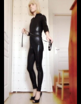 Faustine: Crossdresser Faustine vinyl catsuit with necklace.