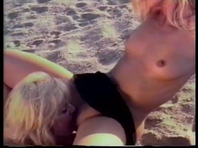 Girl on Girl: Blonde lesbians lovers lick each other on the sandy beach -...