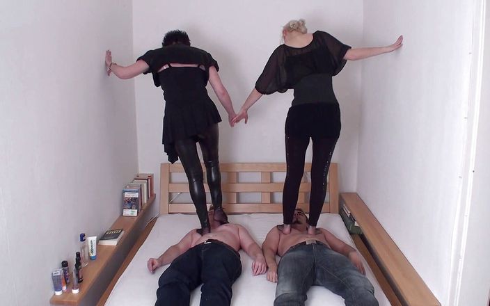 Femdom Austria: Brunette and blonde are trampling on their slaves