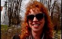Lucky Cooch: साक्षात्कार देते समय लाल बालों वाली महिला धूप का चश्मा पहने हुए
