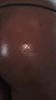 Ebony in thong bikini Marie Star oils up her black ass and tits