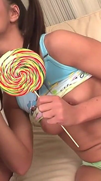Handsome Man Pounds Wet Cunt of a Cute Teen on Armchair While She Sucks a Huge Lollipop