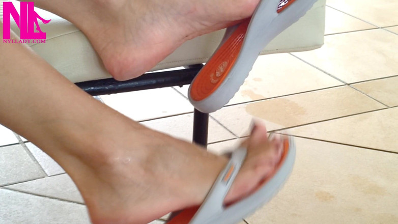 Nyllady: Dangling with Orange Flip Flops in a Swimming Pool