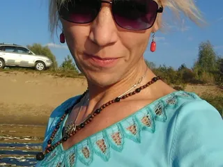Trans Girl Swimming in the Lake in Clothes Blue Blouse and White-milk Pants.