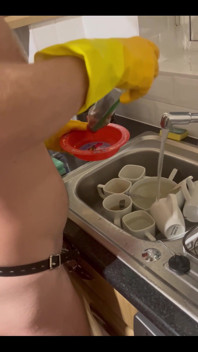 My Chastity Sub Washing the Pots for Me Naked in His Chastity Cage and with His Marigolds on