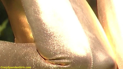 Fetish Islands: Sexy ebony babe in skintight golden spandex catsuit posing outdoor