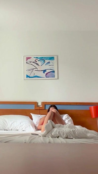 Woman Being Recorded in Hotel Room