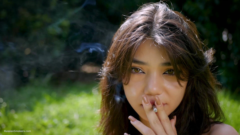 Russian Smokers: Arina Is Smoking One Black Cigarette Outdoors