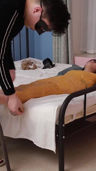 A Cute Barefoot Girlfriend Uses Tape to Bind Her Whole Body, Playing with Her Cute Bare Feet