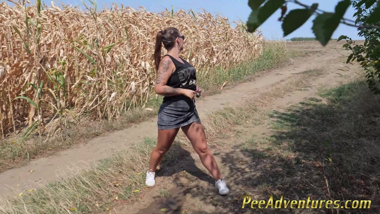 Pee Adventures: Pee standing on a dirt road in the countryside