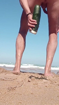 A Young Person Spreads Their Buttocks Apart on the Beach While Others Watch.