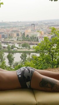 Yuri Is Lying on a Massage Table Against a Beautiful City Backdrop