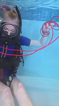 Legato sotto la superficie - scuba stuzzica e gioca con la corda nel wetsuit vintage