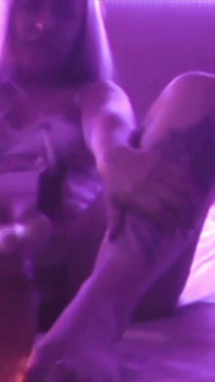 Young Girl Using Her Feet to Play with the Dildo While Masturbating