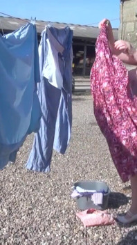 Trisha hanging out the washing