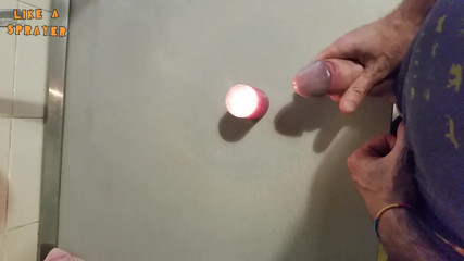 Like a sprayer: Candle cumshot by handjob