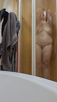 A Busty BBW Showering in the Shower Cabin, Shaving Her Armpits, Pussy, and Legs.
