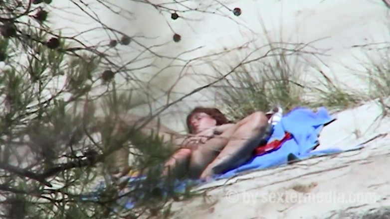 Sextermedia by Pete: Redhead beauty dildoing pussy on the sandy beach