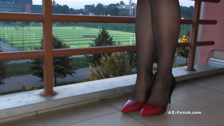 Aqua Pola: Dipping classic red high heels on balcony