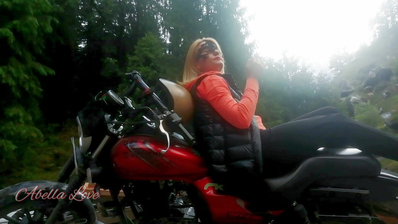 Abella Love: Red lips blonde smoking sensually on Rasta bike outdoor