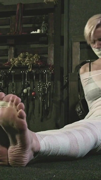 Astrid aux pieds nus se fait momifier avec des bandages blancs et bâillonner