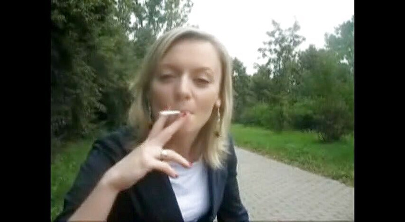 Femdom Austria: Blonde beauty smoking a cigarette outdoors