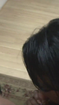 Two black women with natural tits and big asses suck a huge black cock