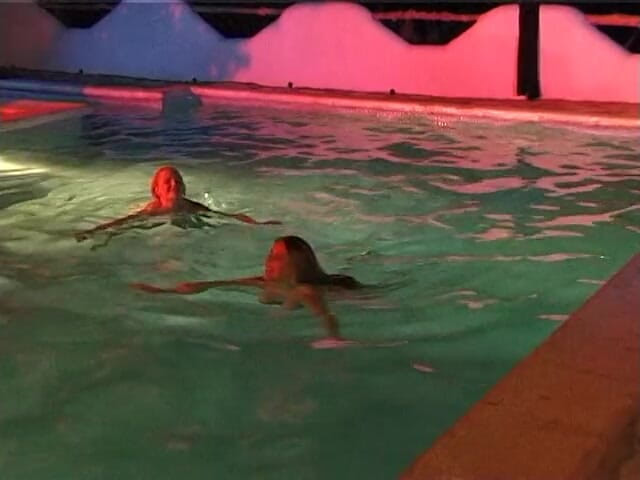 Naughty Girls: Two sexy lesbian chicks are swimming together in the swimming...