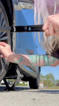 67 Tall Amazon Goddess Changes Her Tire - Big Feet in Frame