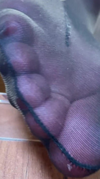 Goddess with Long Legs and Big Ass in Black Pantyhose on the Table Plays with a Toe Ring Above Your Face