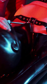 Heavy rubber masked latexgirl stretched and tickled