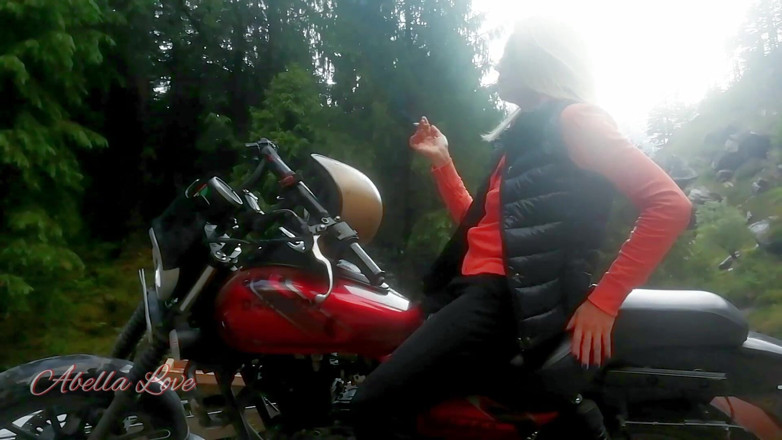 Abella Love: Red lips blonde smoking sensually on Rasta bike outdoor
