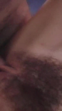 The Guy Drills the Brunettes Hairy Pussy on the Table While Holding Her Tits Tightly