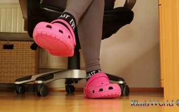 Under Desk Foot Play – Pink Clogs and Worn Socks