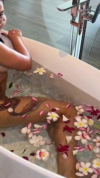 Bath of Blossoms Naked MILF Masturbates Among Flowers