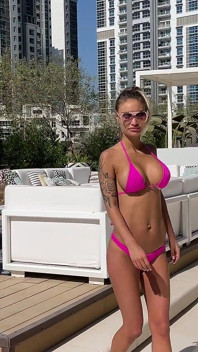 Monika Fox Poses in Pink Bikini and Swims in Pool Surrounded by Skyscrapers
