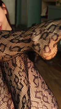 I'm Posing in a Black Fishnet Bodysuit and Heels, Pleasuring Myself with My Fingers.