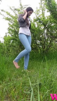 Skinny Brunette Just Had a Pee in the Tall Grass and Now She Puts on Her Jeans and Shoes